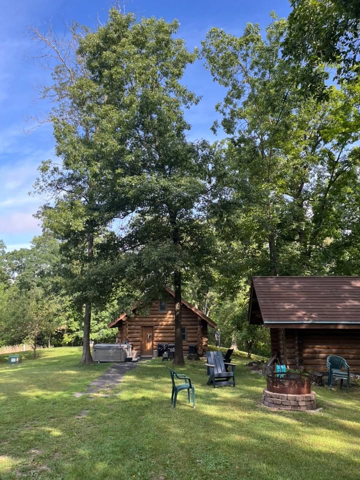 A photo of a cabin surrounded by trees.
